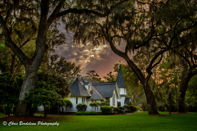 Christ Church Frederica located on northern Saint Simons Island under a twilight sky. Christ Church is set in tall, mossy grass under towering oak trees. The church grounds include a cemetery. Christ Church, one of the oldest churches in Georgia, was founded on St. Simons Island nearly 70 years after the island was first settled by English colonists. Worship has been continuous since 1736 in Christ Church Parish, established by English colonists at Frederica under General James Oglethorpe.